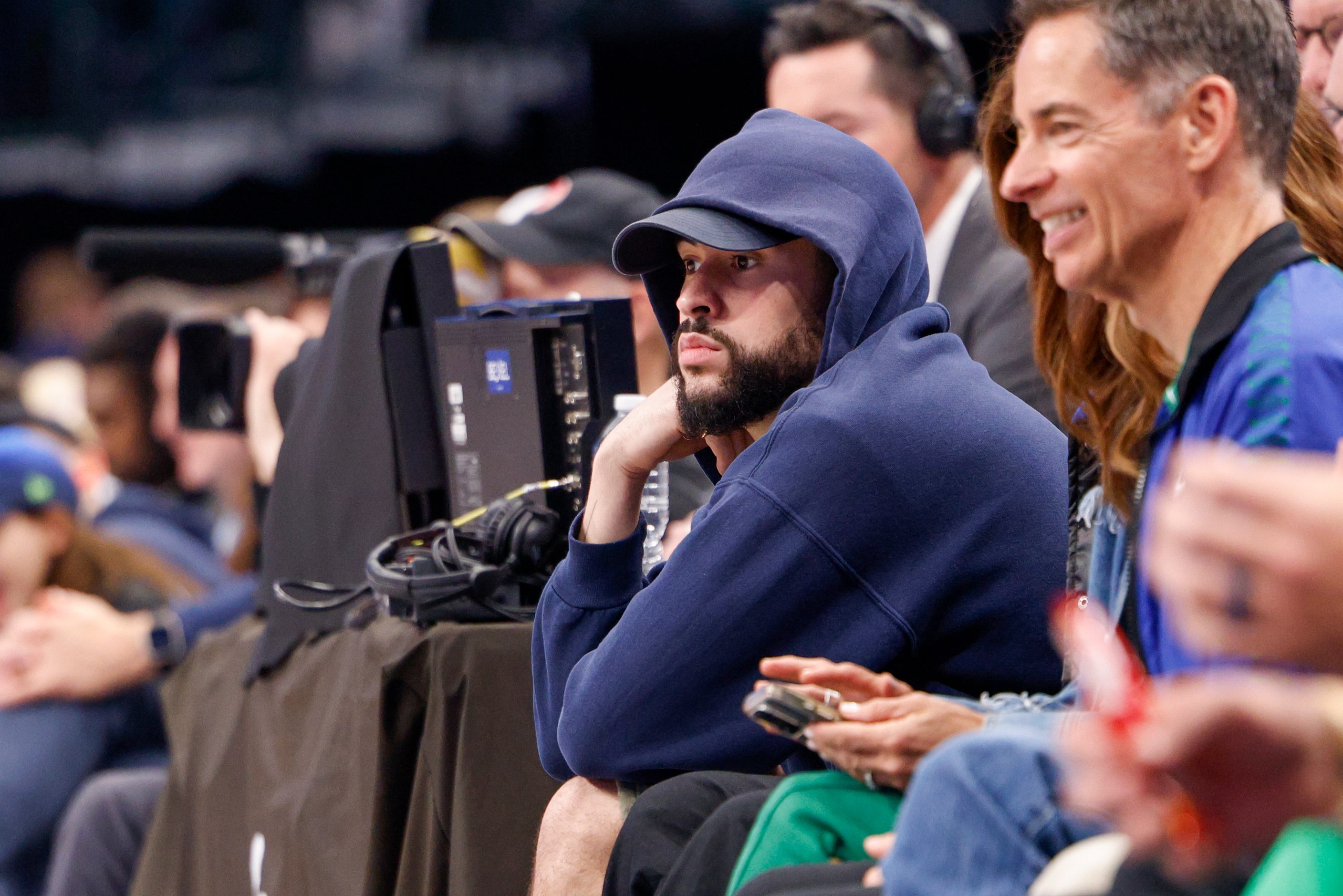 Puerto Rican recording artist Bad Bunny watches the first half of Game 6 of an NBA...