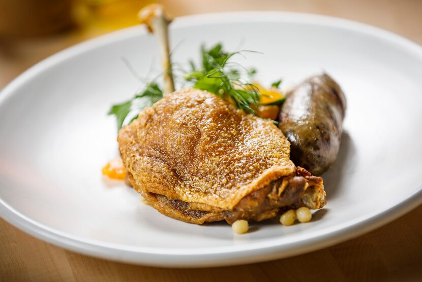 Duck leg and duck sausage with fregola salad, apricots and pine nuts.