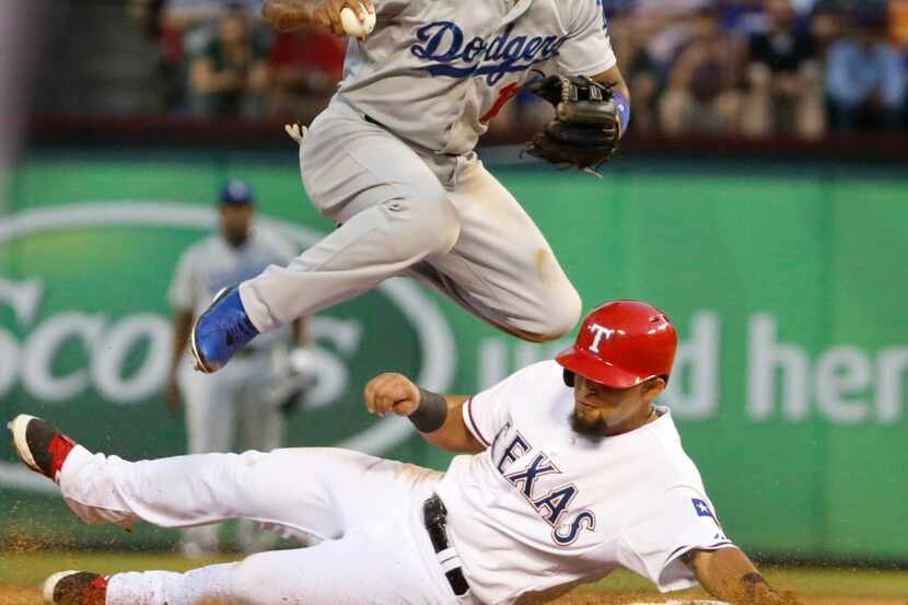 Texas second baseman Rougned Odor slides in hard at second to break up a double play, as...