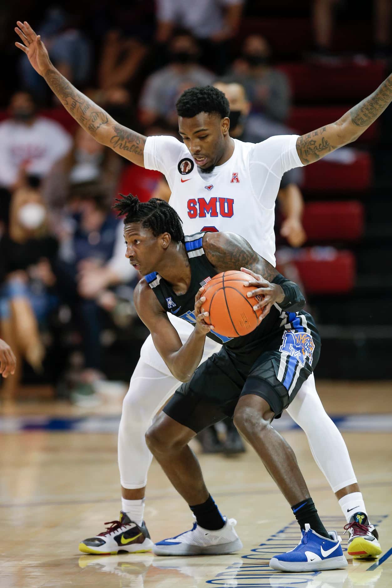 SMU guard Tyson Jolly (0) defends against Memphis guard Damion Baugh (10) during the first...