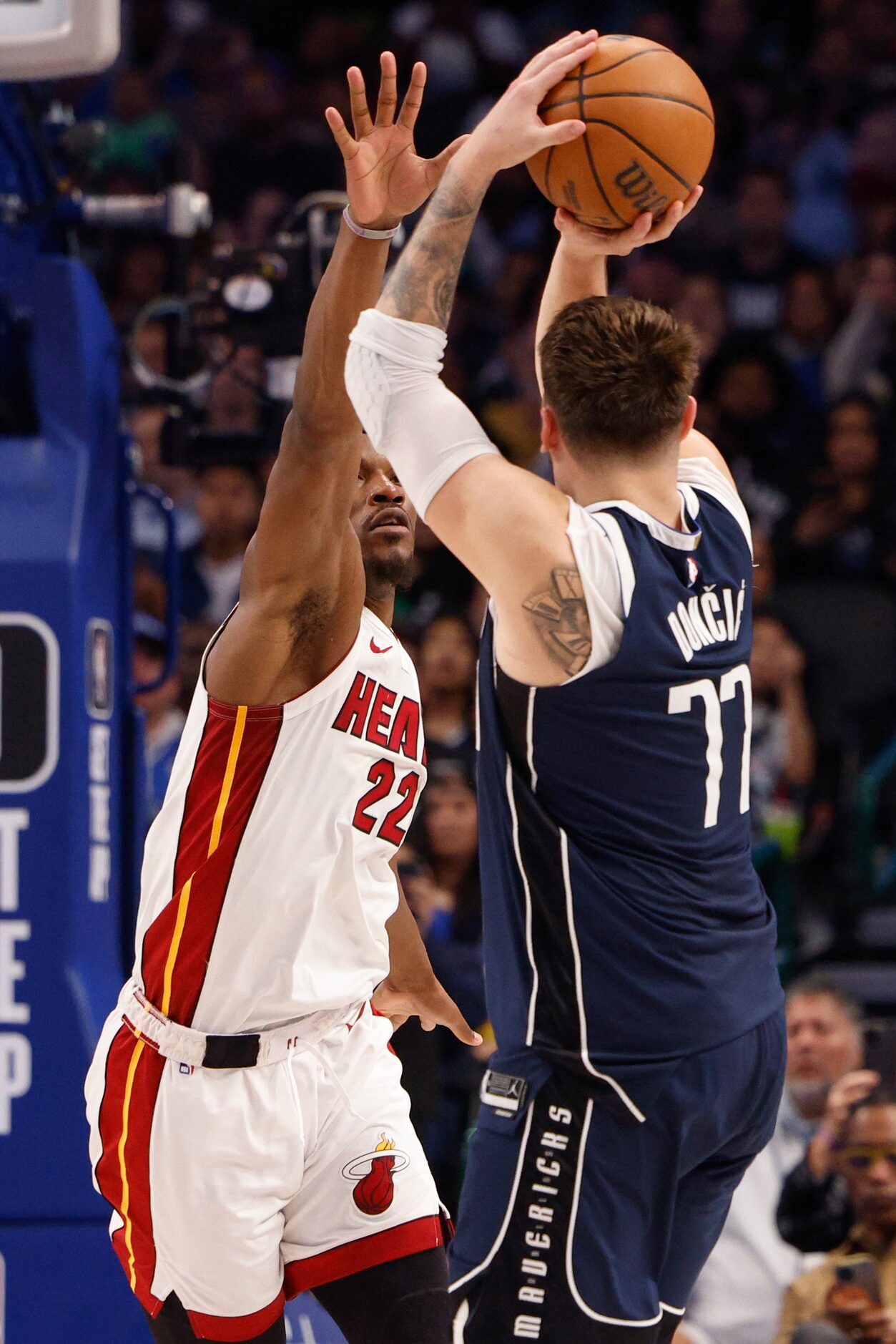 Dallas Mavericks guard Luka Doncic (77) shoots over Miami Heat forward Jimmy Butler (22)...