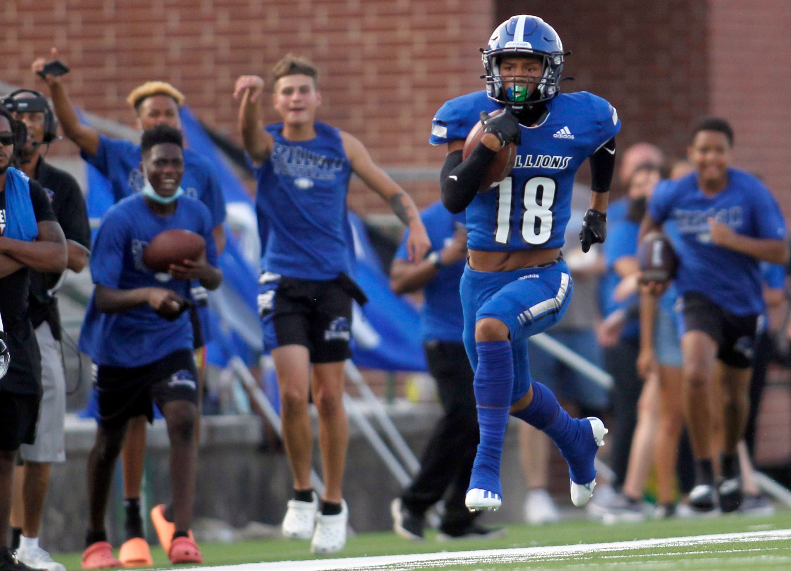 North Mesquite receiver Elijah Baesa (18) rambles down the sideline on  a kickoff return...