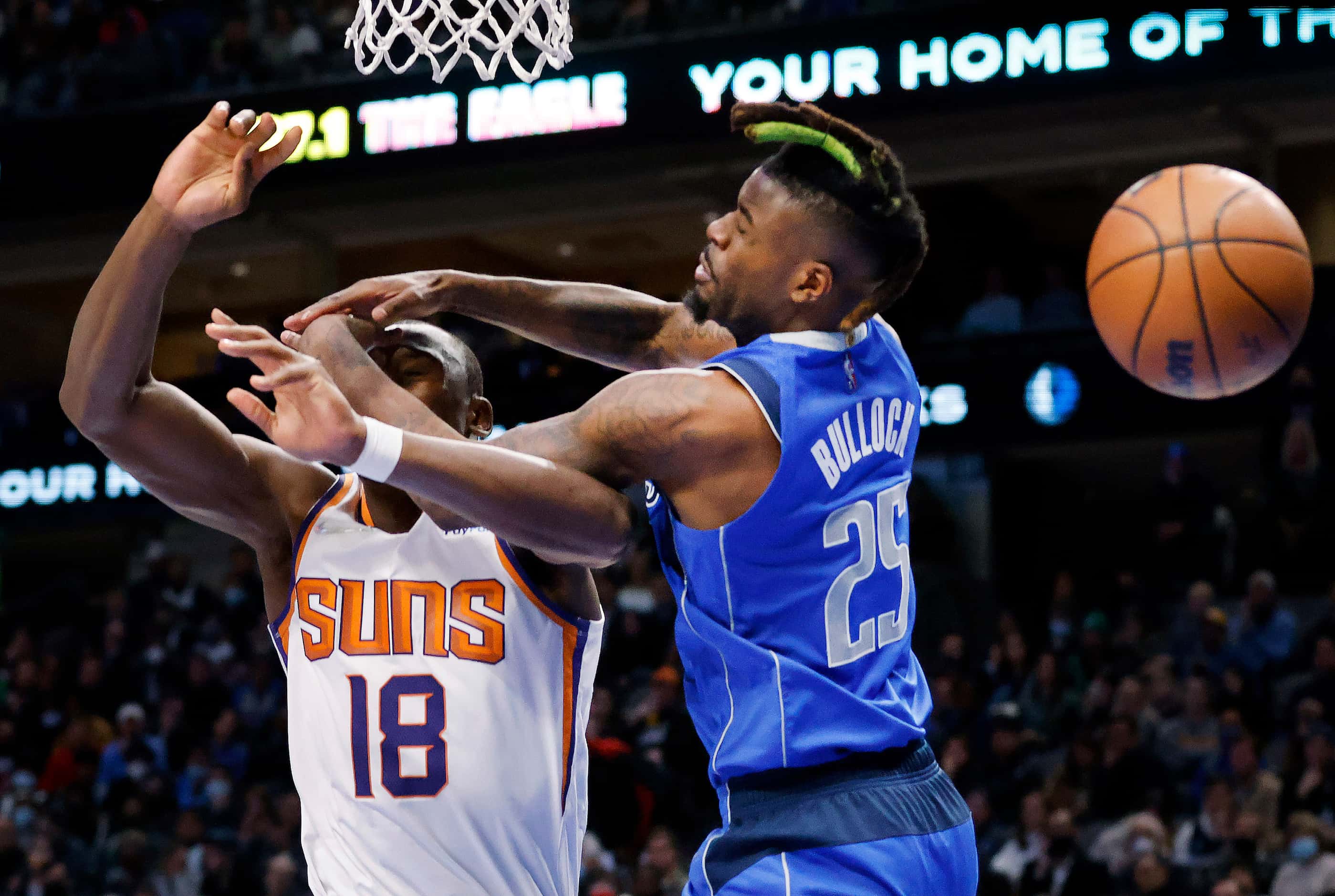 Dallas Mavericks forward Reggie Bullock (25) fouls Phoenix Suns Bismack Biyombo (18) during...