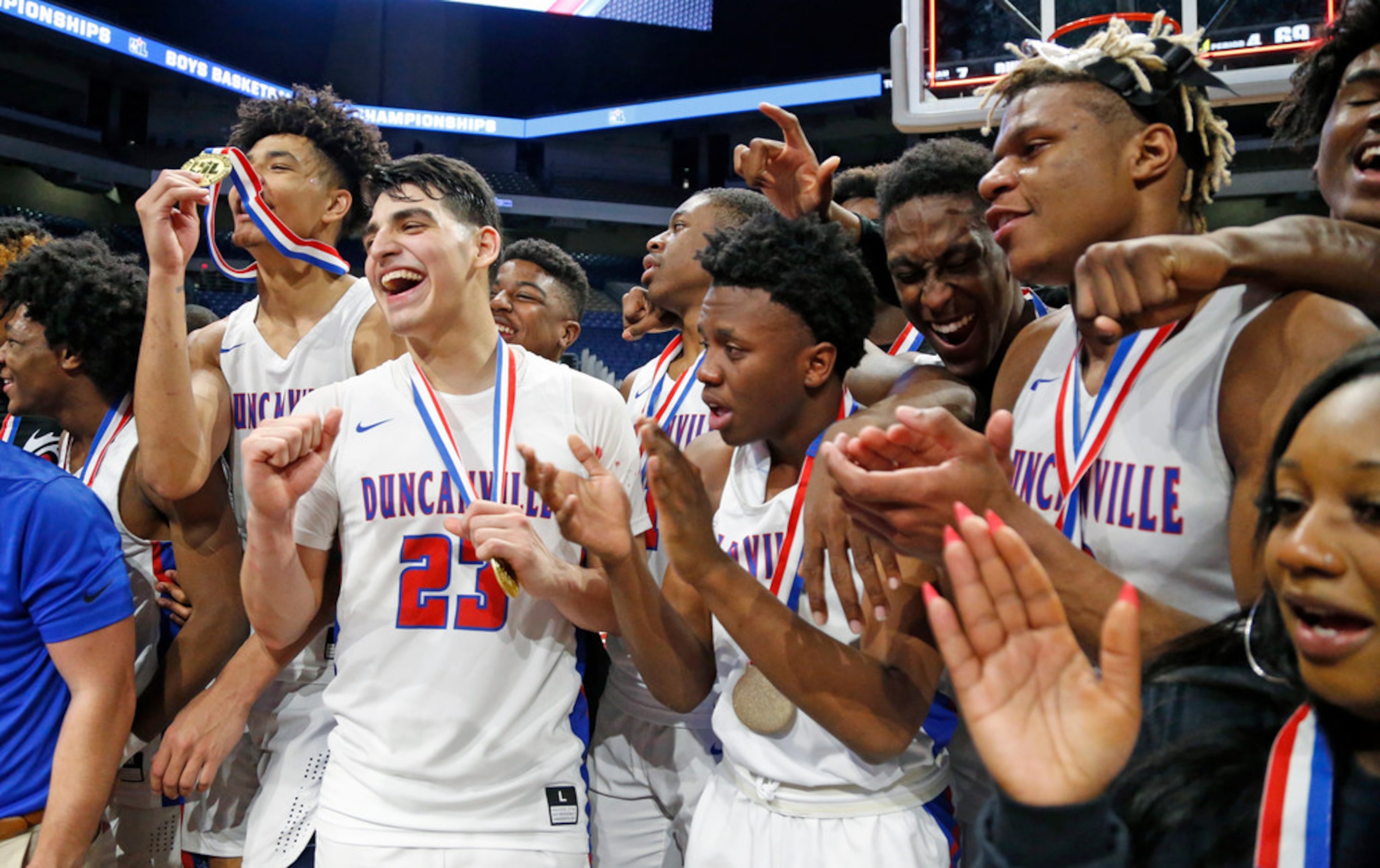 Duncanville players celebrate their 69-73 win against Klein Forest in a UIL boys basketball...