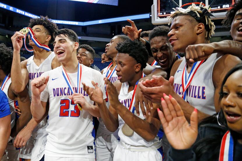 Duncanville players celebrate their 73-69 win against Klein Forest in the Class 6A state...