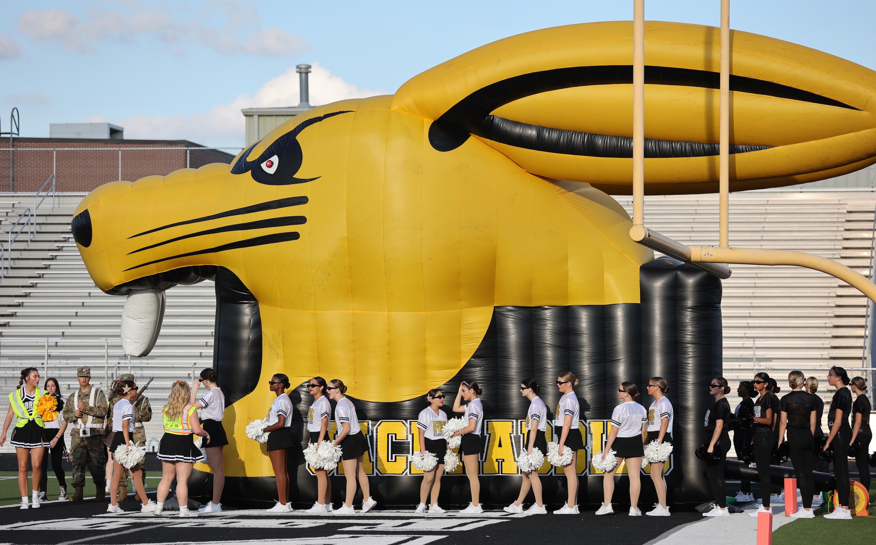 The Forney drill team members prepare to enter the field by a large Jackrabbit blowup before...