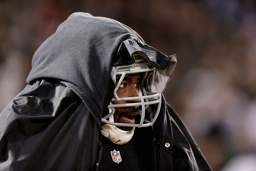 OAKLAND, CA - DECEMBER 24: Benson Mayowa #95 of the Oakland Raiders looks on from the bench...