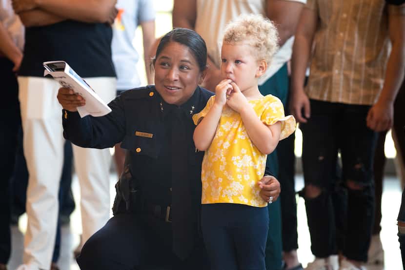Assistant Chief Angela Shaw points to police Officer Chelsea Boykin while staying close to...