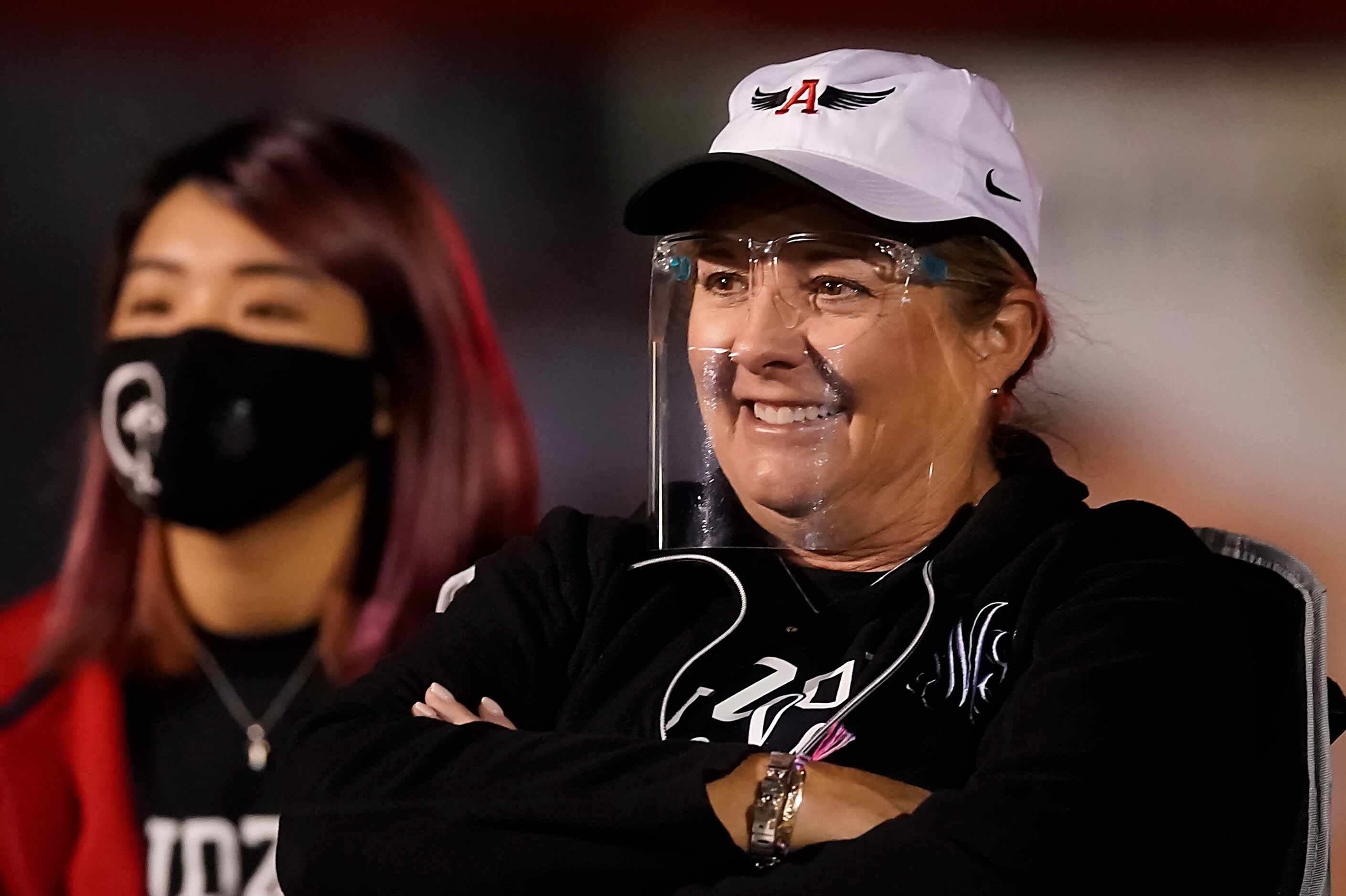 Argyle fans wear face masks and face shield s during the first half of a high school...