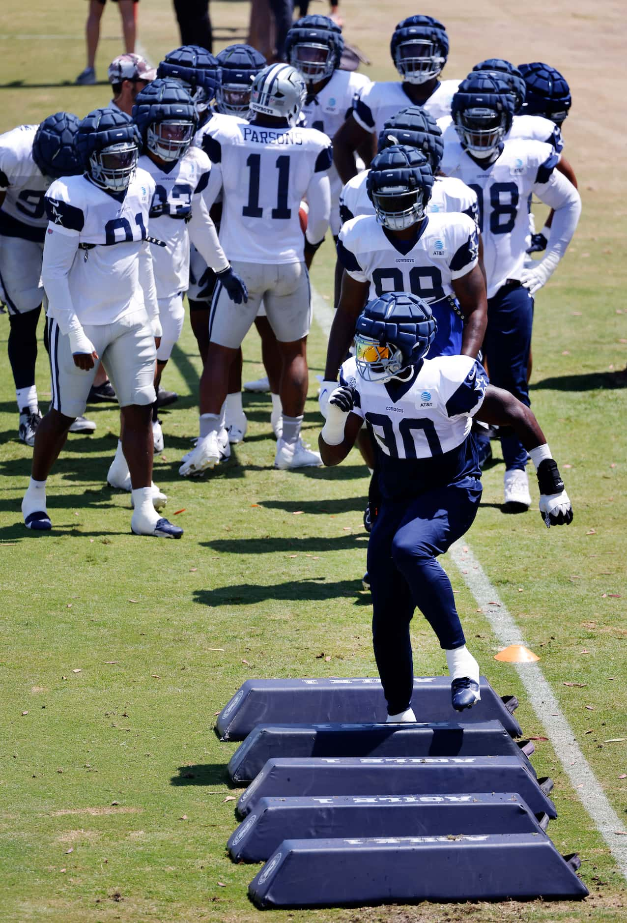 Dallas Cowboys defensive end DeMarcus Lawrence (90) leads the way with feet work drills...