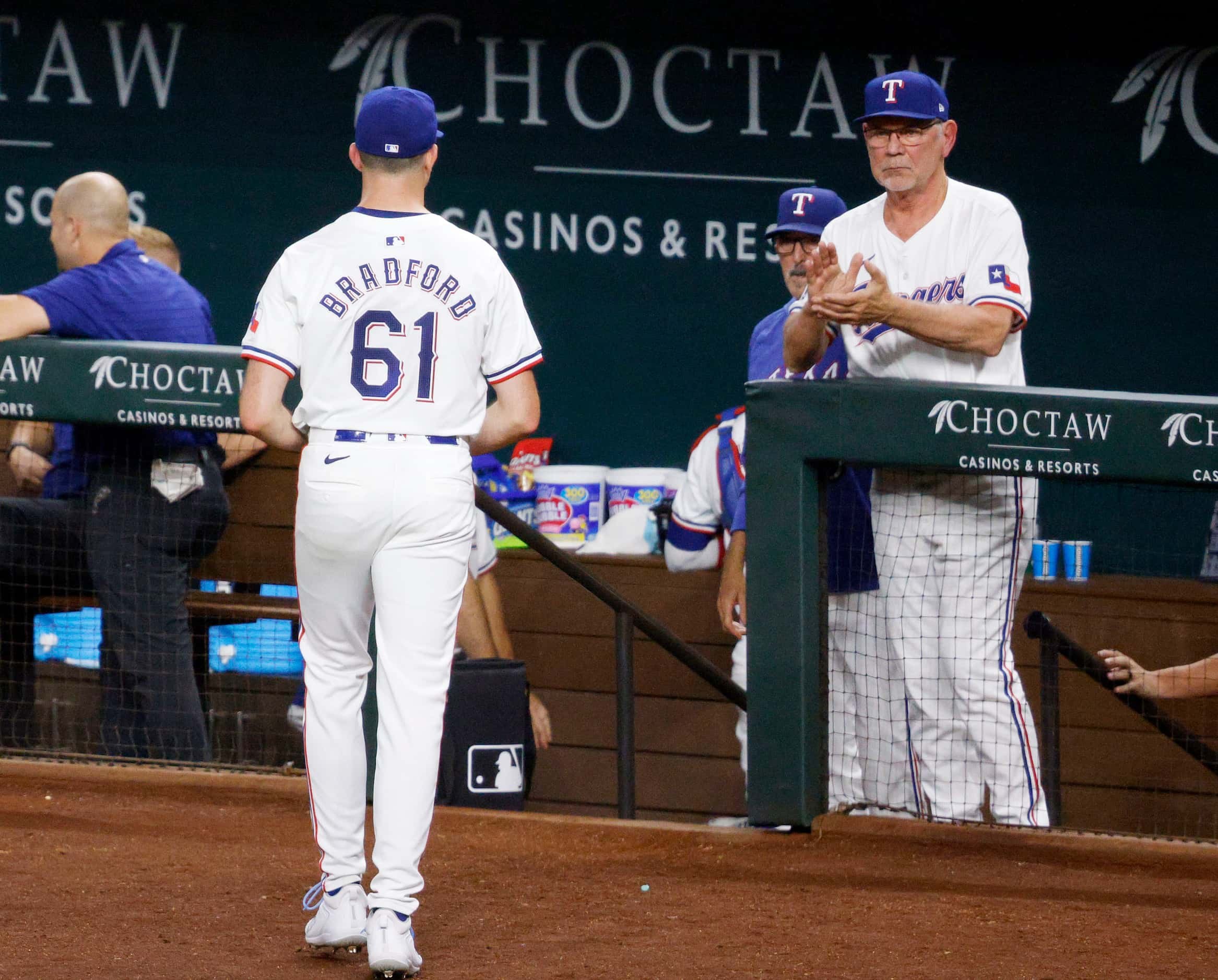 Texas Rangers pitcher Cody Bradford (61) walks to the bench as Texas Rangers manager Bruce...