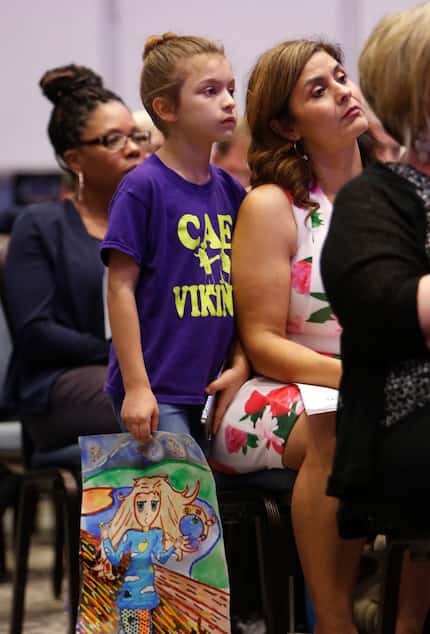 Kennedy Bruner, 10-year-old former student of art teacher Stacy Bailey holds a piece of...