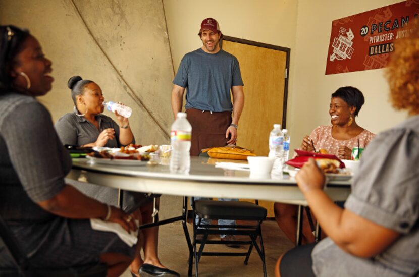 Pecan Lodge owner and pitmaster Justin Fourton visits with Mesquite diners (from left)...