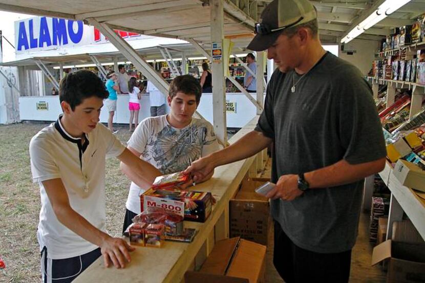 
Plano residents Erick Martinez (left), 17, and Adam Jimenez, 16, are helped by Jonathan...