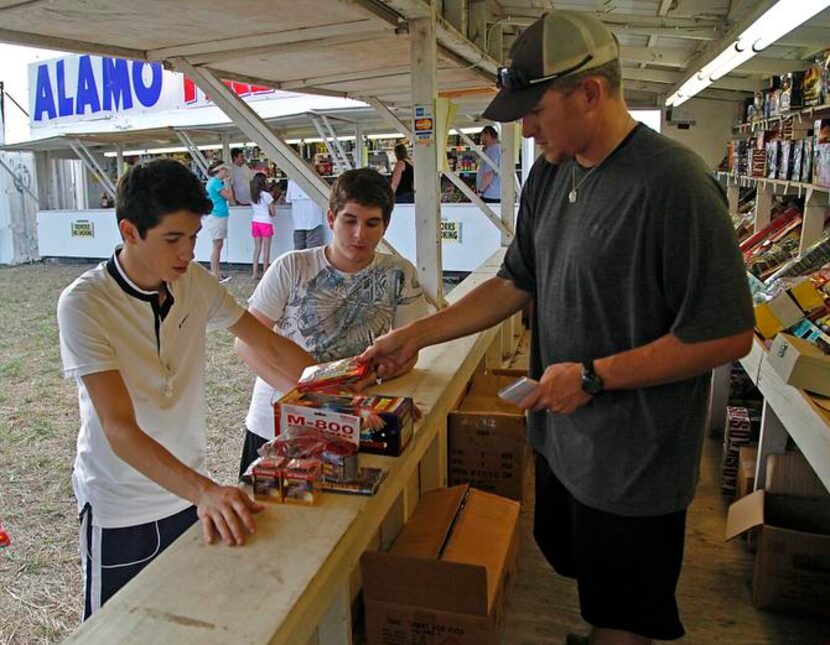 
Plano residents Erick Martinez (left), 17, and Adam Jimenez, 16, are helped by Jonathan...