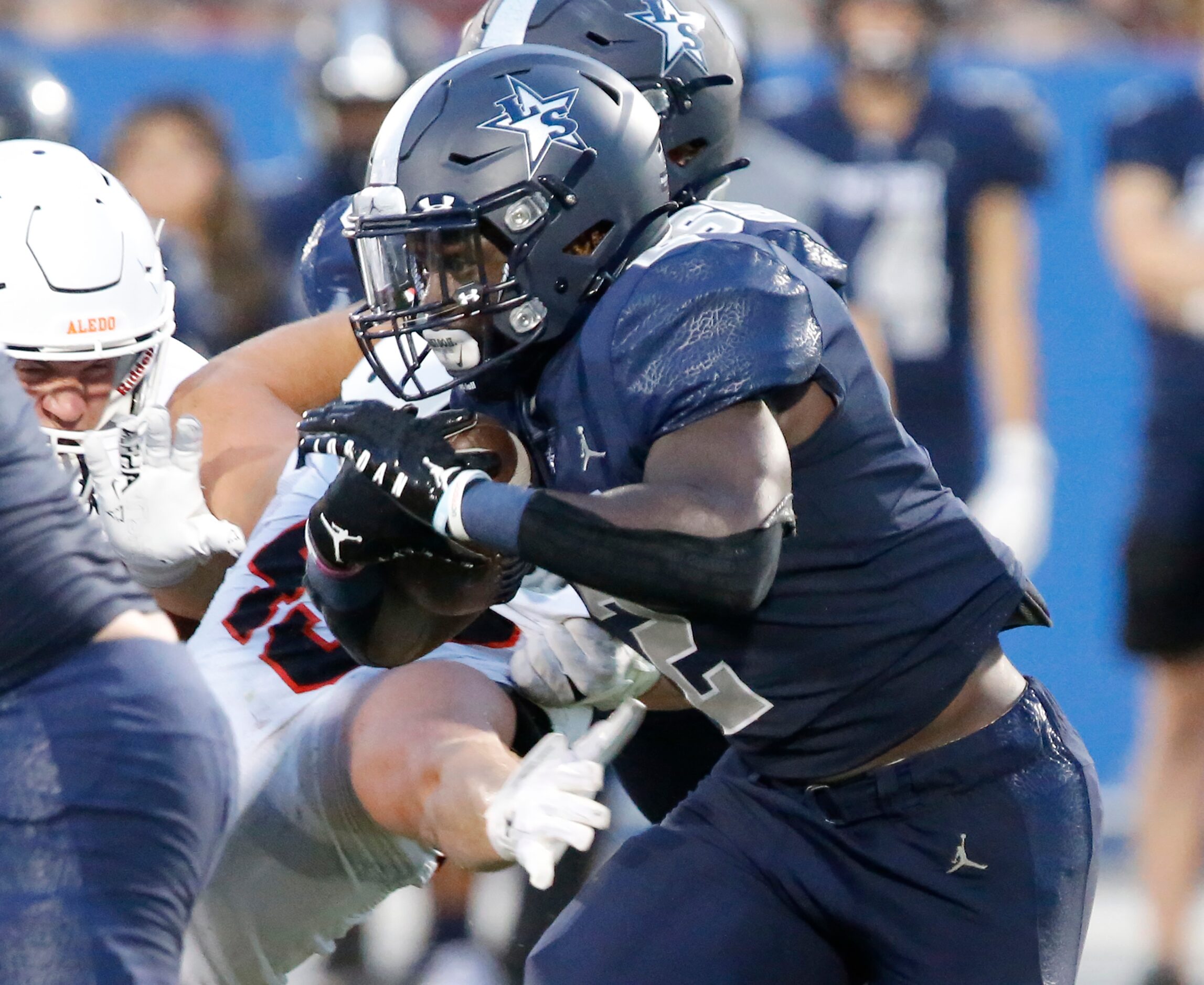 Lone Star High School running back Ashton Jeanty (2) looks for room to run during the first...