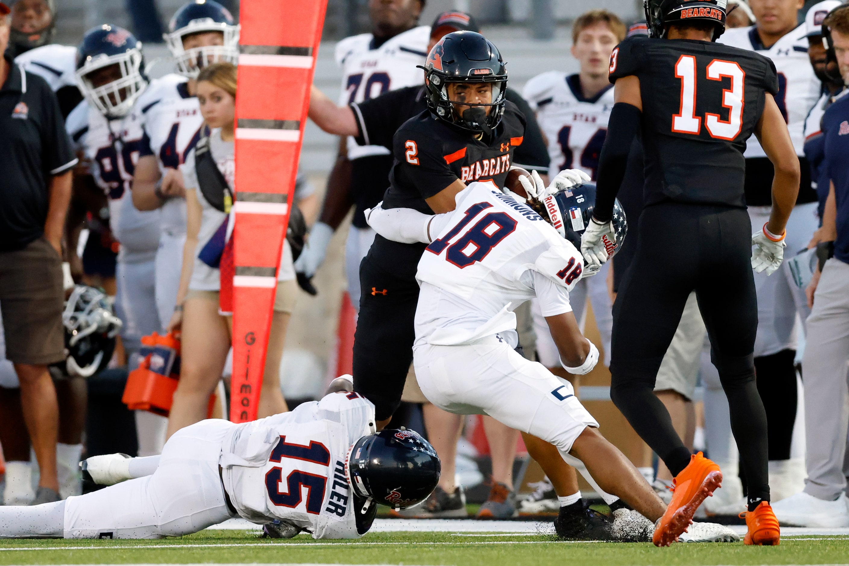 Denton Ryan defensive back Xaier Hiler (15) and running back Byran Simmons (18) tackle Aledo...