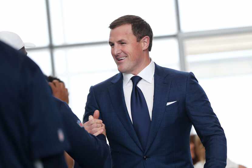 Dallas Cowboys tight end Jason Witten is greeted by players and coaches walking into a news...