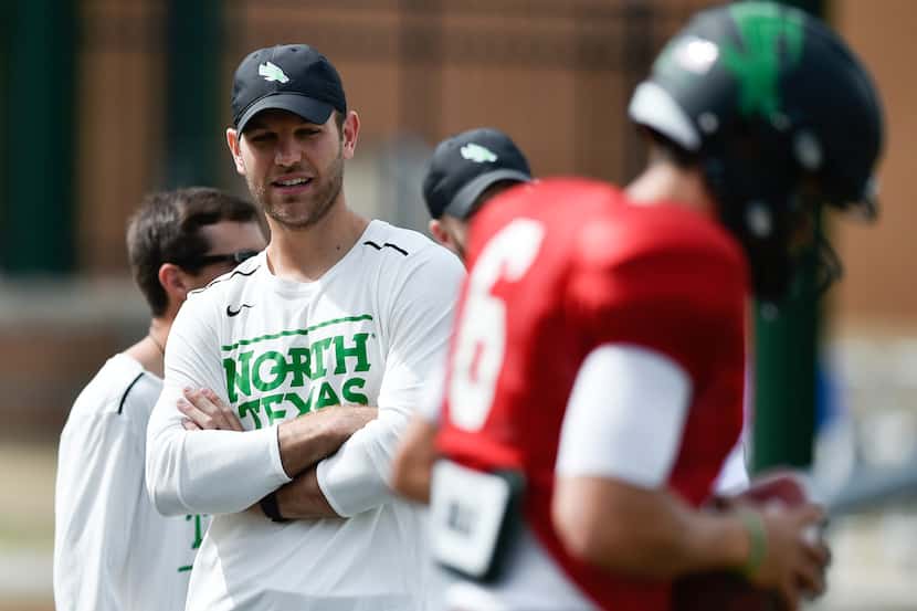 North Texas offensive coordinator Graham Harrell watches his players warmup before the start...