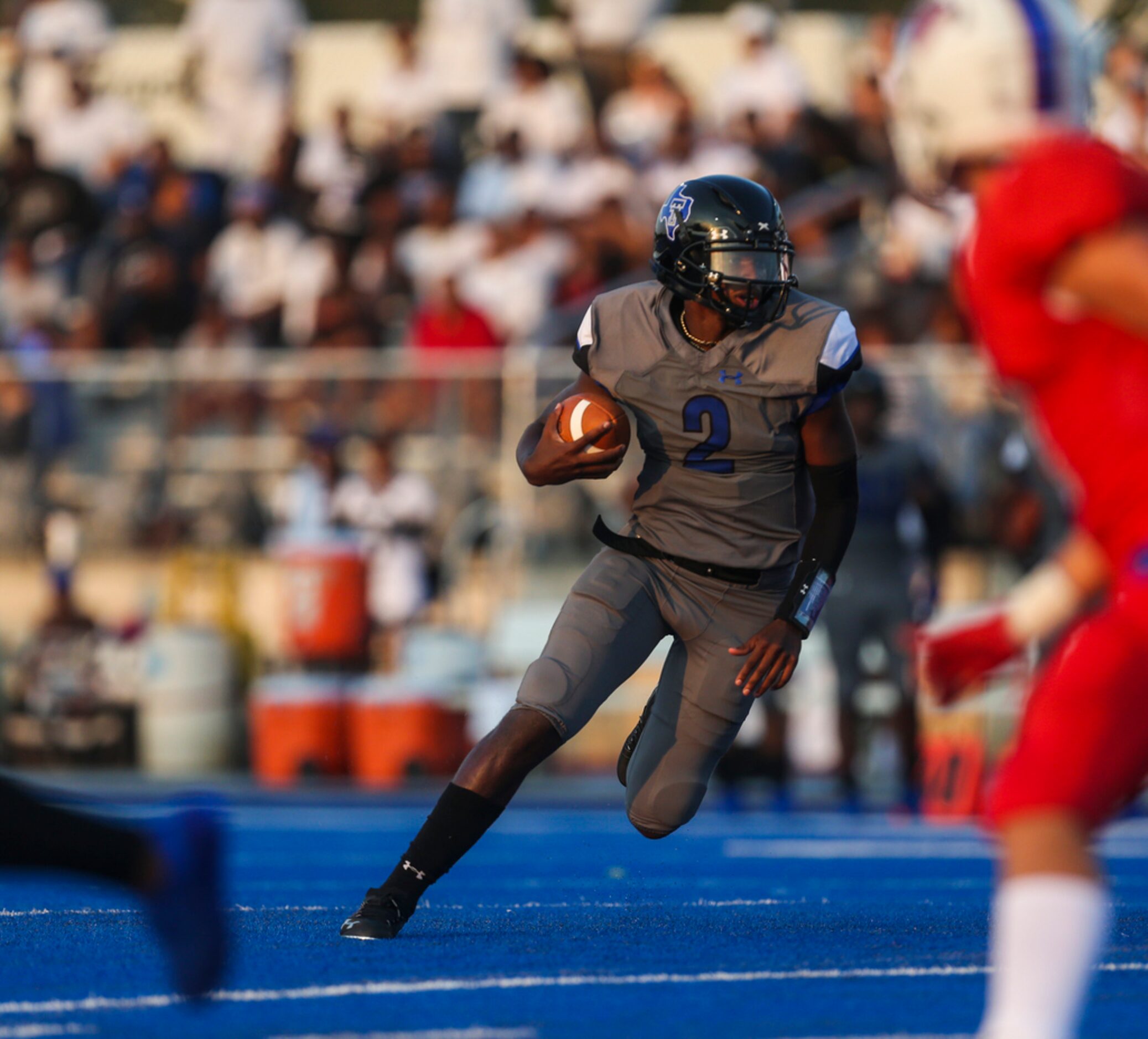 Trinity Christian-Cedar Hills quarterback Shedeur Sanders (2) makes a break during a high...