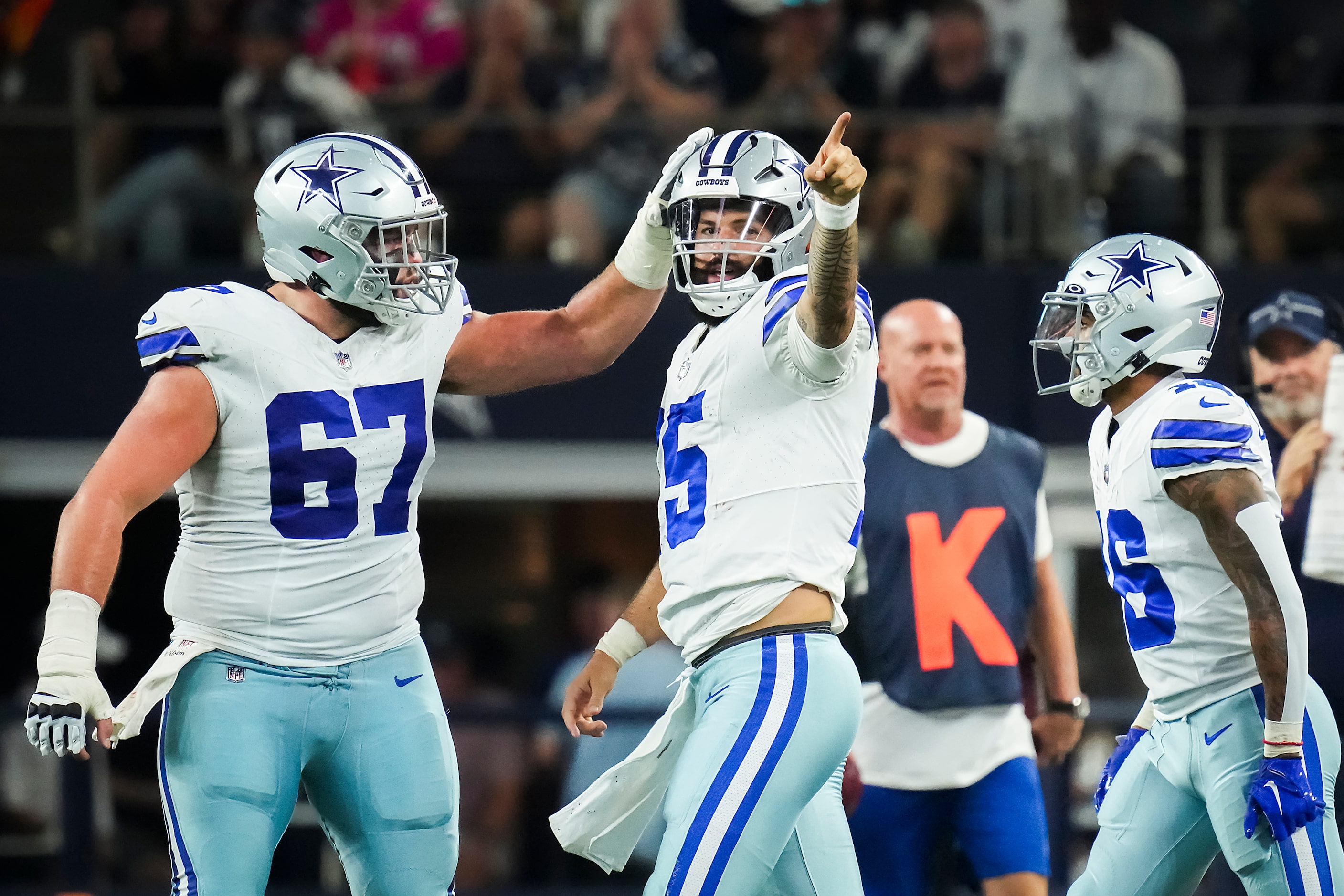 Dallas Cowboys quarterback Will Grier (15) celebrates with center Brock Hoffman (67) after...