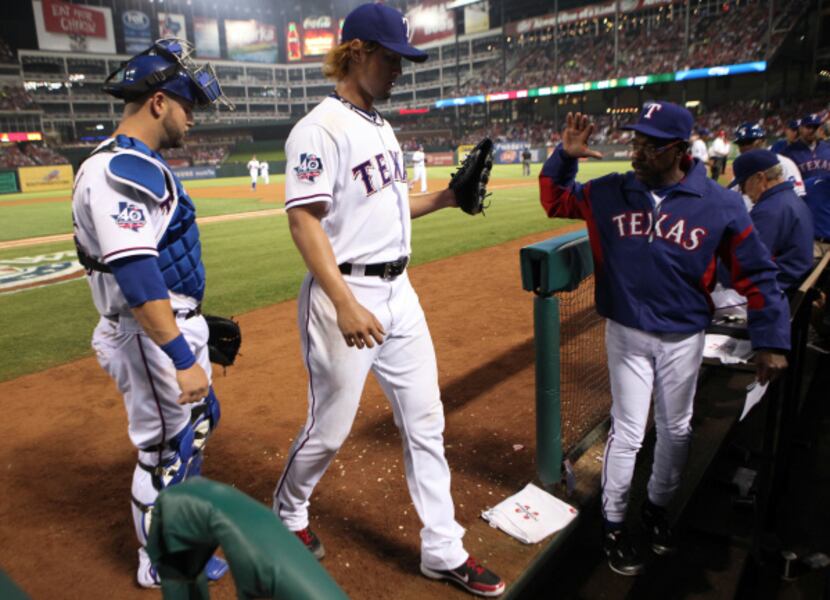 Texas RF Nelson Cruz is greeted at home plate by jubilant teammates  after hitting an 11th...