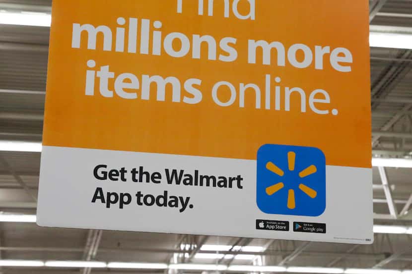 Signs informing customers about Walmart's online shopping at the Walmart Supercenter at...