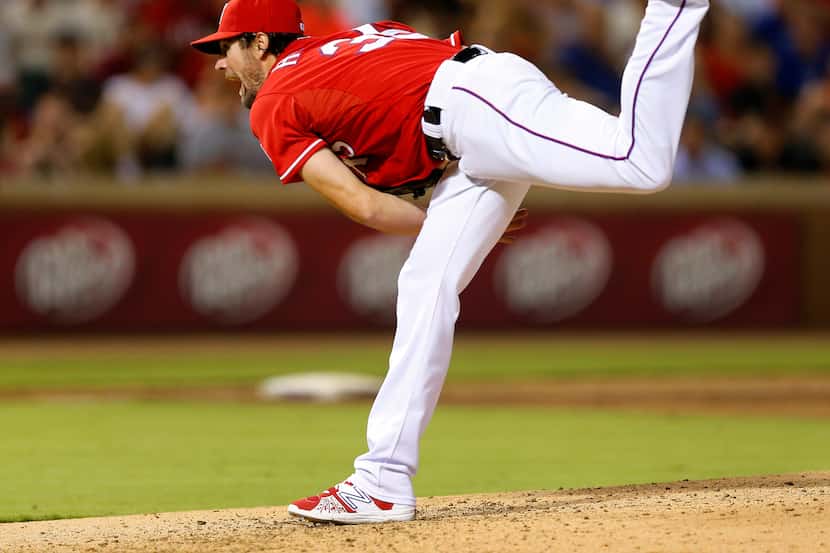 Texas Rangers starting pitcher Cole Hamels (35) fllowings through on striking out San...