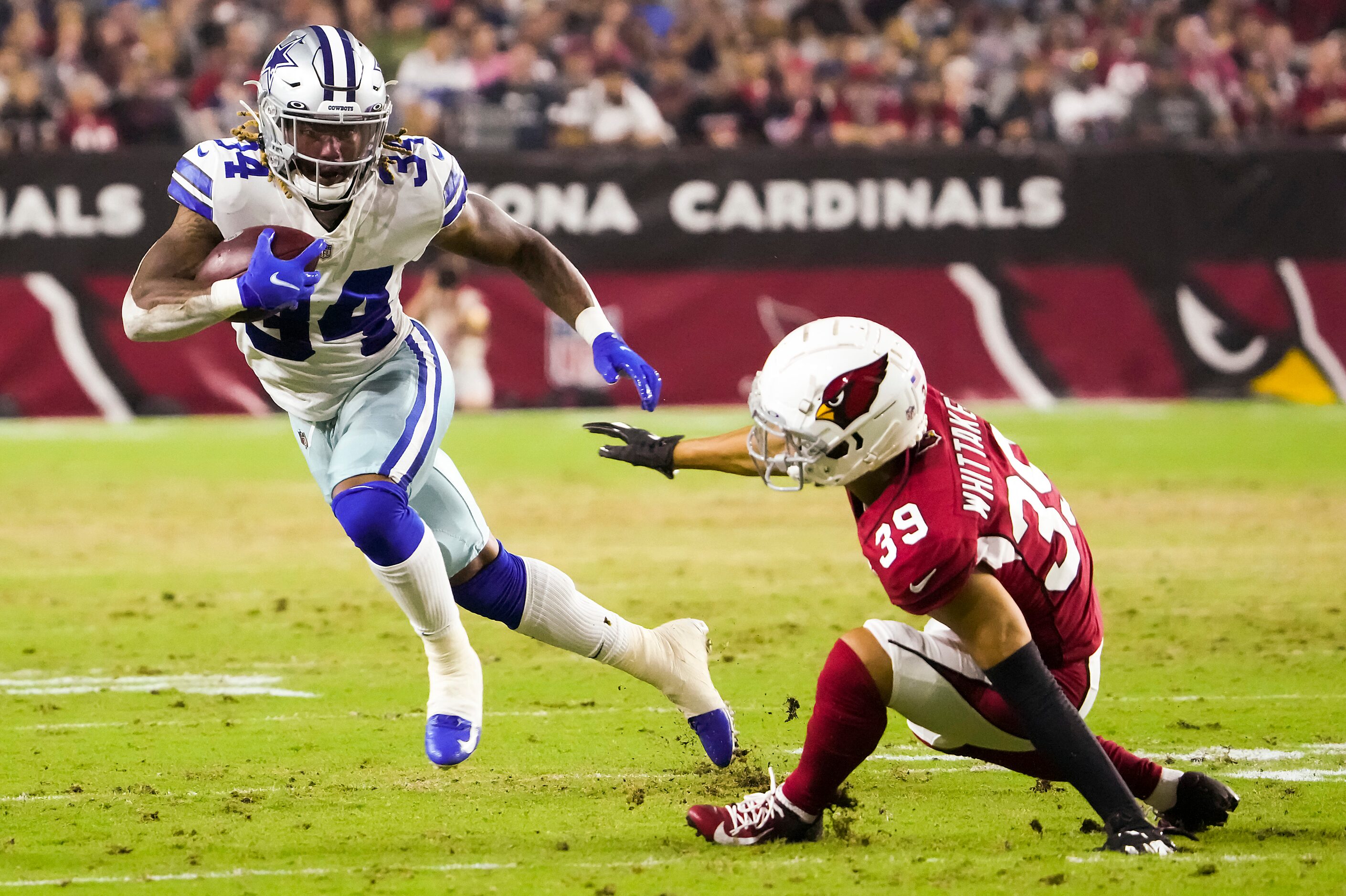 Dallas Cowboys running back Rico Dowdle (34) gets past Arizona Cardinals cornerback Jace...