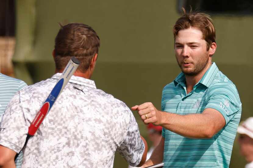 Sam Burns and Bryson DeChambeau bump fists after completing round 2 of the AT&T Byron Nelson...