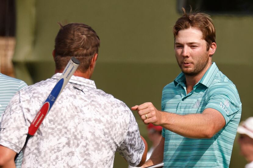 Sam Burns and Bryson DeChambeau bump fists after completing round 2 of the AT&T Byron Nelson...