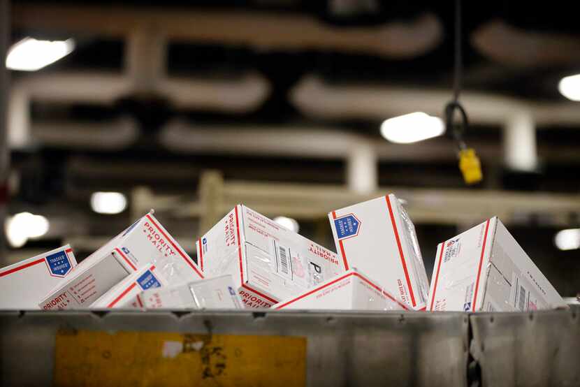 Priority Mail parcels fill a large container at the US Postal Service's North Texas...