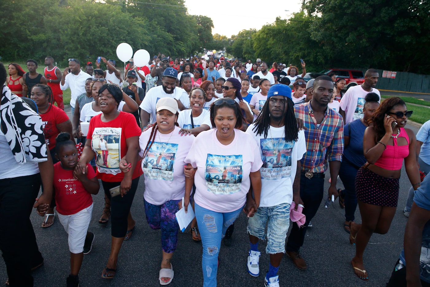 Mourners march down Sunnyvale led by Shavon Randle's mother, Shaquna Persley (glasses on...