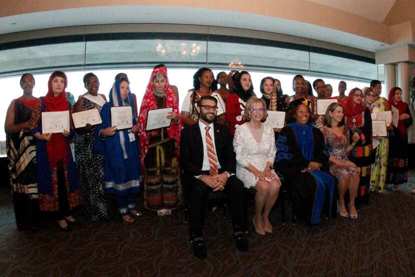 A group of women from Afghanistan and Rwanda gathered for a group photo after their...