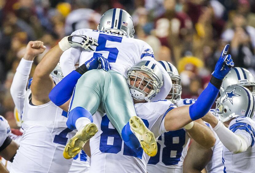 Dallas Cowboys tight end Jason Witten (82) lifts kicker Dan Bailey (5) in celebration after...