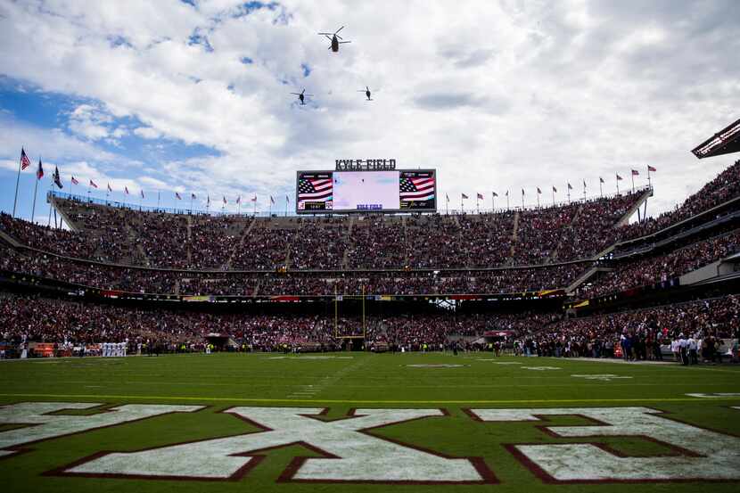 Helicopters fly over Kyle Field before a college football game between Texas A&M and Alabama...