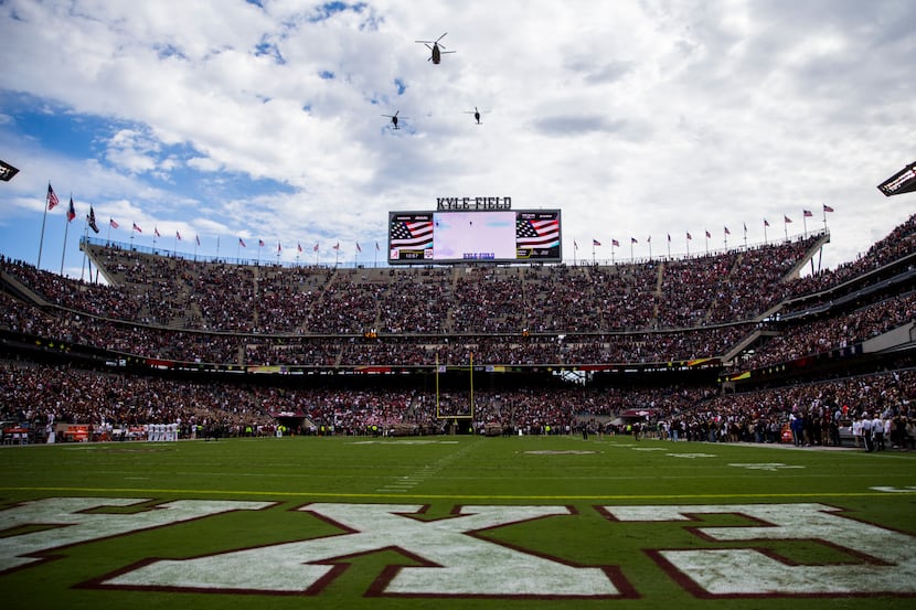 FILE - Helicopters fly over Kyle Field before a game between Texas A&M and Alabama on...