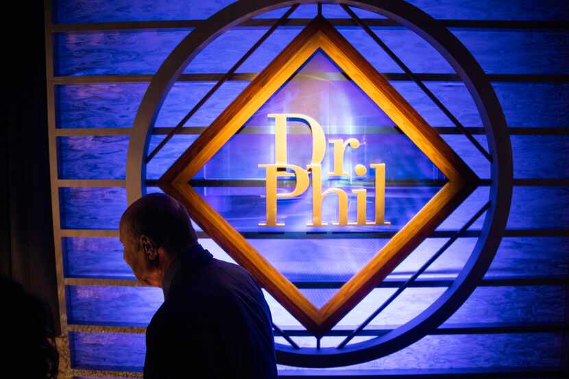 Phil McGraw, better known as Dr. Phil, walks by the 20-year-old ‘Dr. Phil’ sign from his old...