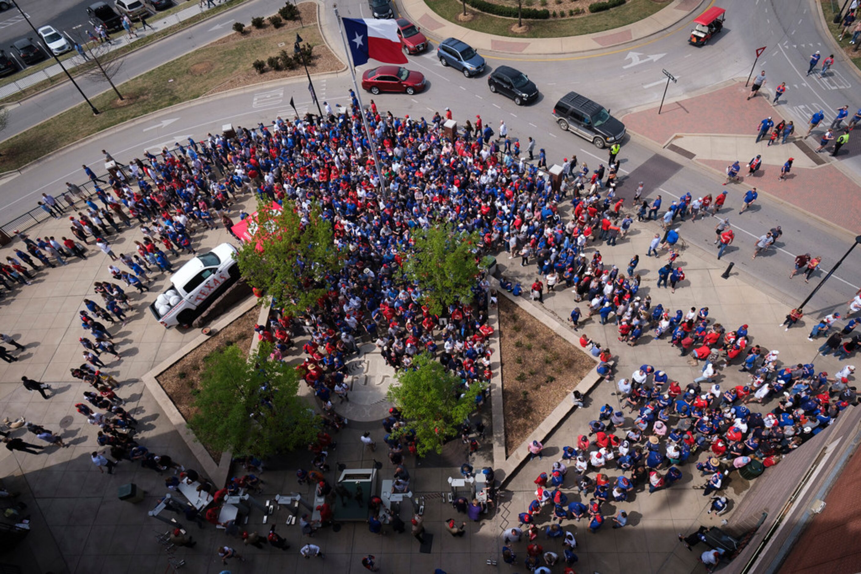 About one half hour before first pitch, fans wait in long lines to go through security and...