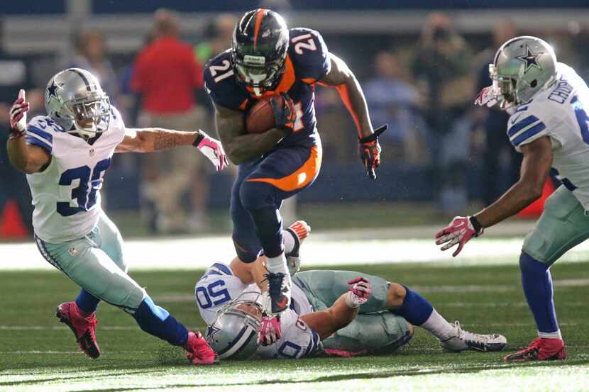 Denver Broncos running back Ronnie Hillman (21) motors for yardage as Dallas Cowboys Orlando...
