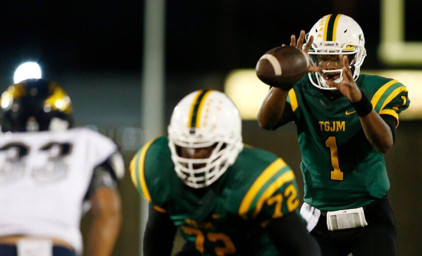 Madison quarterback Travion Jackson (1) takes the snap as offensive lineman Jeremy Terrell...