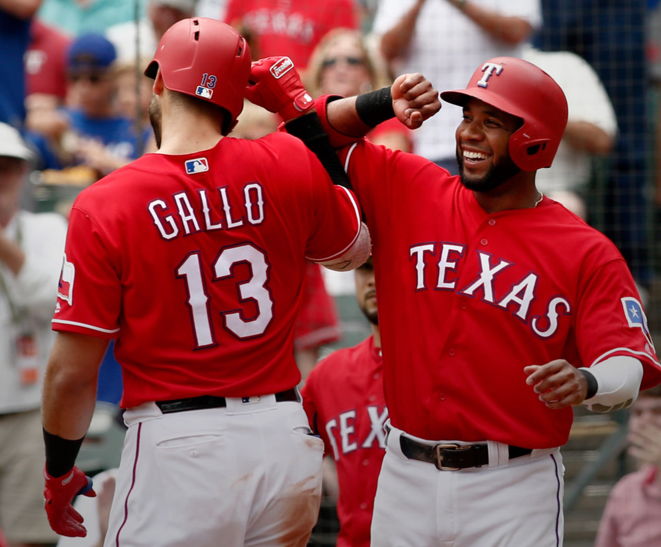 Texas Rangers Joey Gallo (13) is congratulated by Elvis Andrus after he hit a home run...