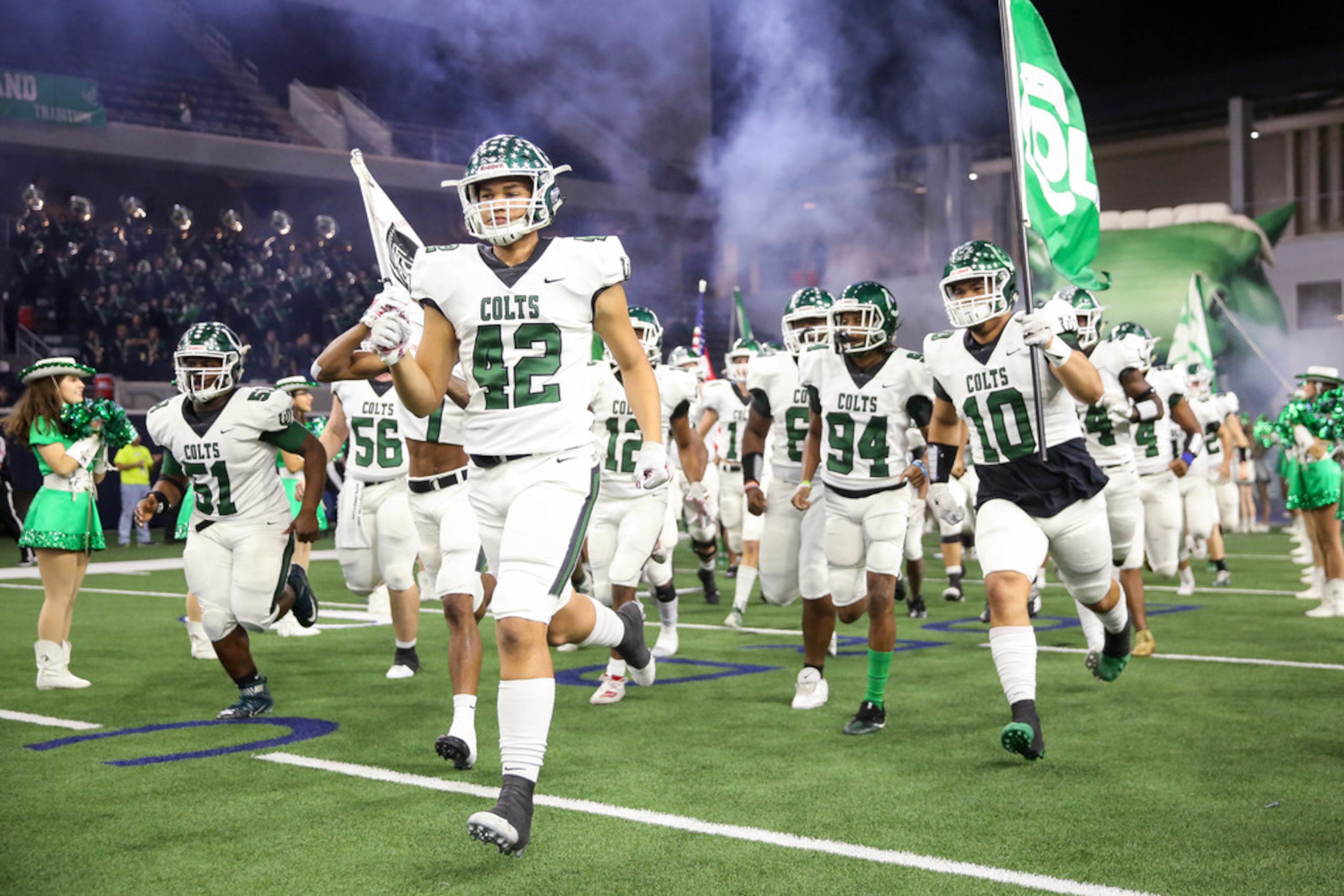 The Arlington Colts run out for the start of a Class 6A Division II Region I semifinal game...