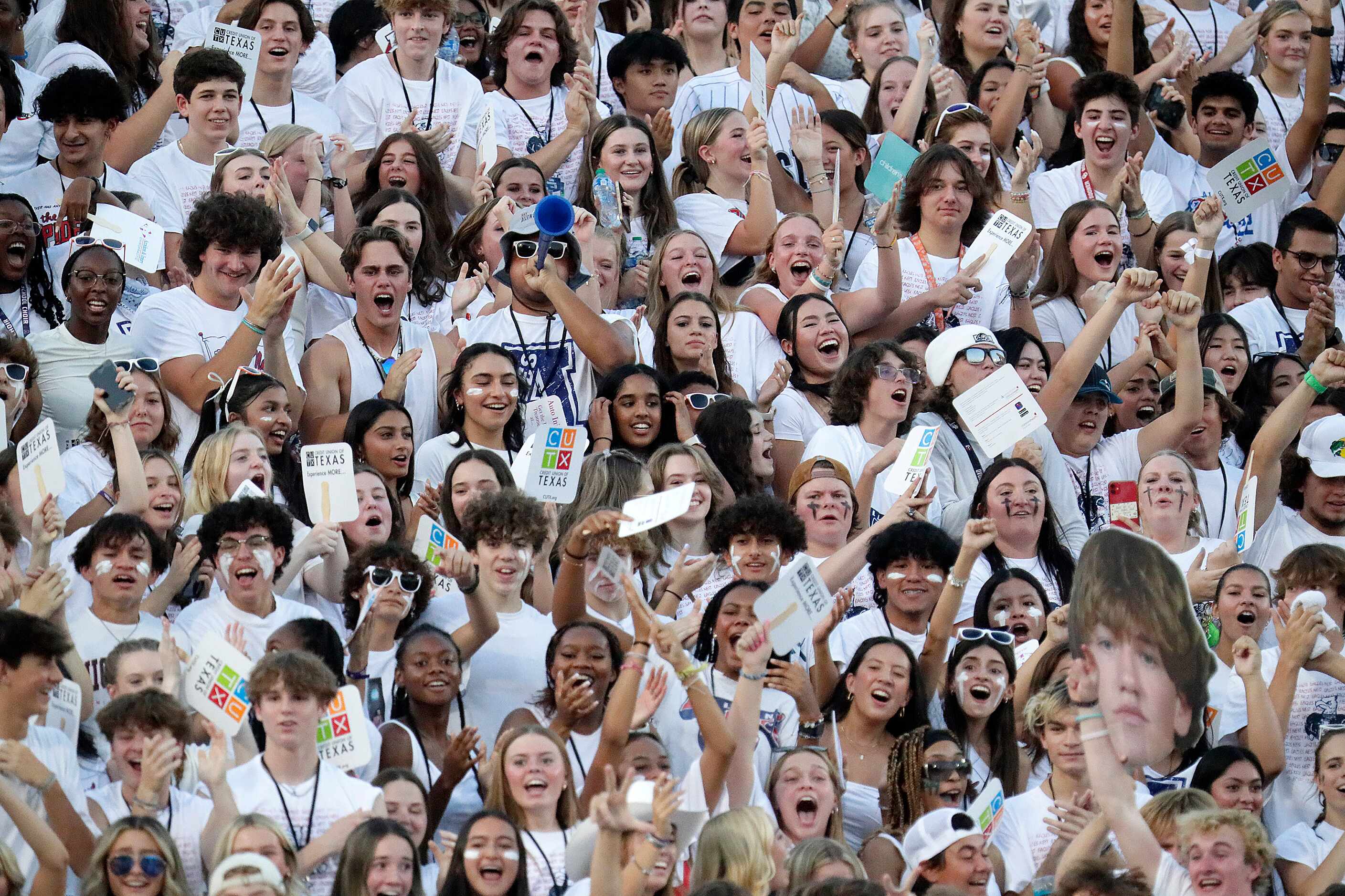 The Allen High School student section celebrates the season's first touchdown during the...