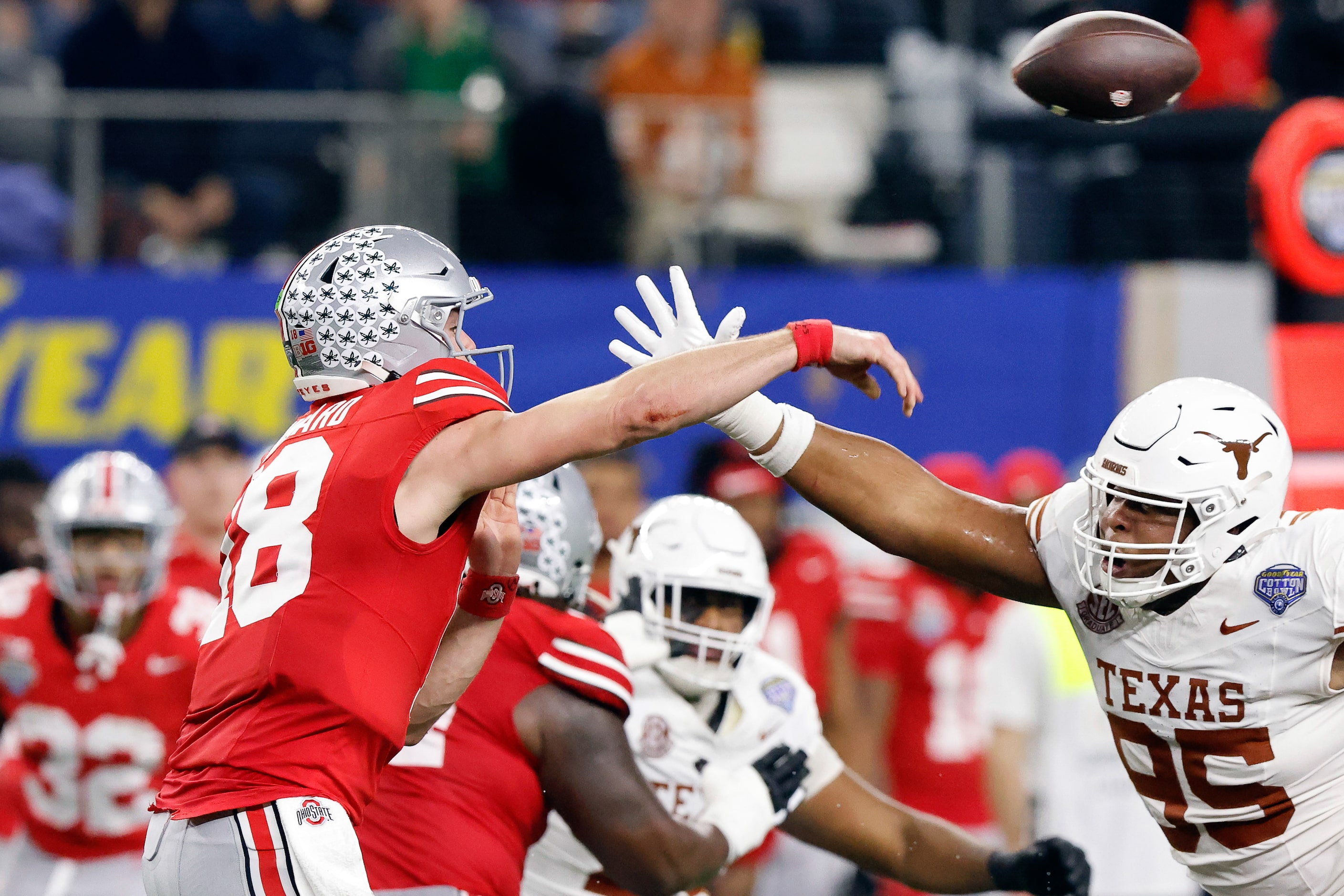 Texas Longhorns defensive lineman Alfred Collins (95) gets a hand up as Ohio State Buckeyes...