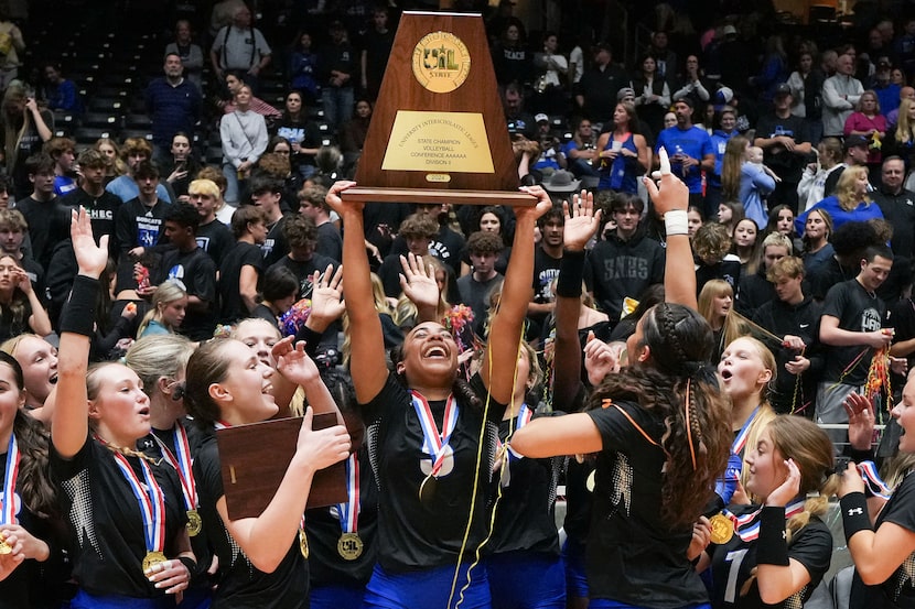 Trophy Club Byron Nelson's Sydnee Peterson  lifts the trophy with teammates as they...