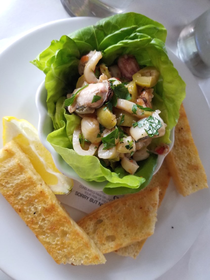 Olive-studded ceviche arrives in a lettuce shell at Del Porto Ristorante, a top-flight...