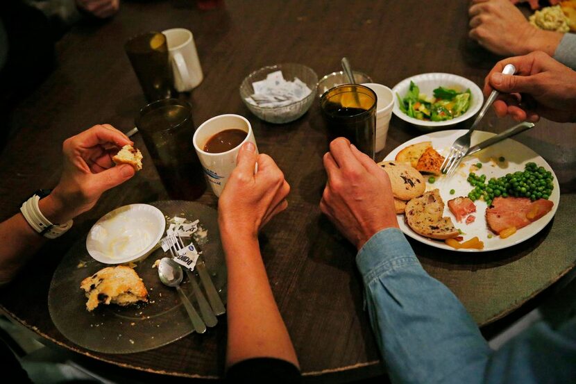 
Clients eat a hot lunch at the Resource Center on Reagan Street in Dallas. The center...