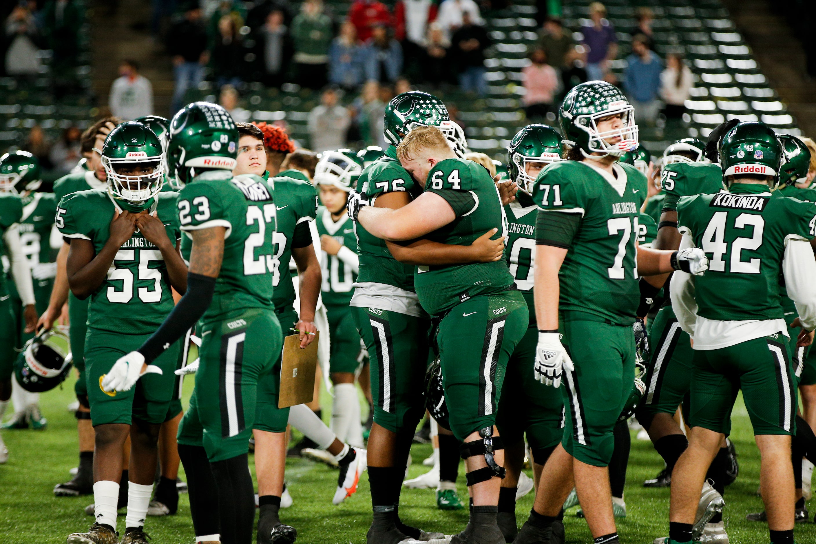 The Arlington varsity team reacts after falling 38-31 to Denton Guyer in double overtime...