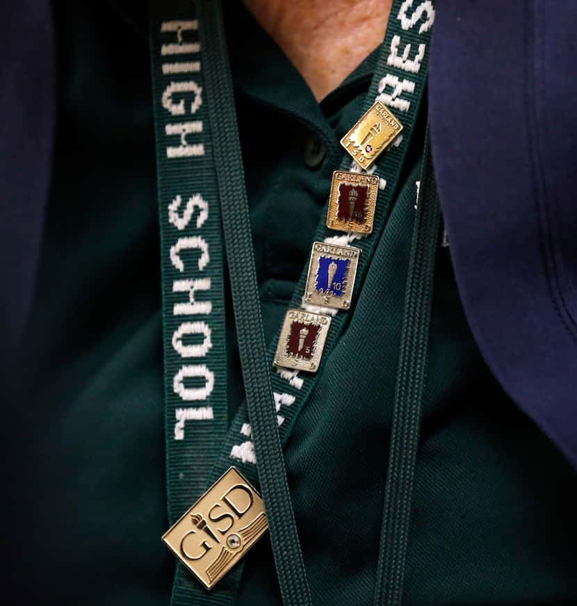 Sharon Bradley wears her 5,10, 15, 20 and 25 years of service pins on her Naaman Forest High...